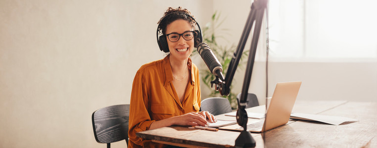 Woman recording podcast at home