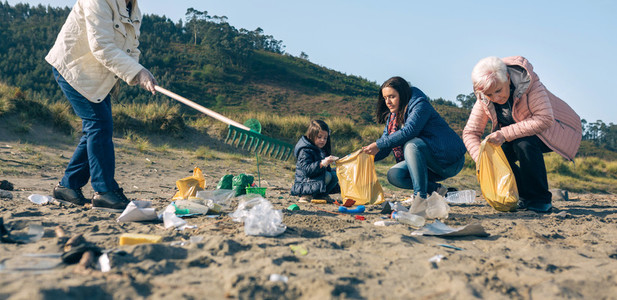 Female volunteers cleaning the beach