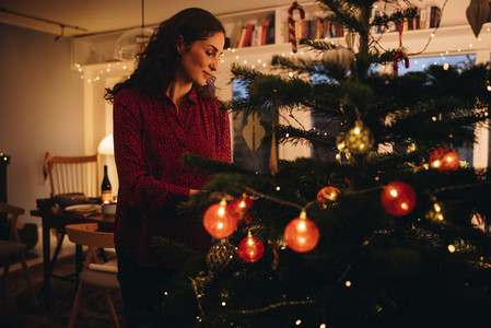 Woman decorating Christmas tree