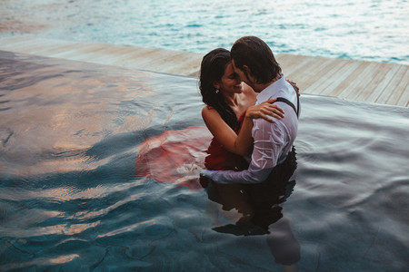 Couple in love romancing in swimming pool