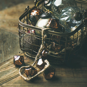 Christmas decoration balls in basket over wooden background  square crop