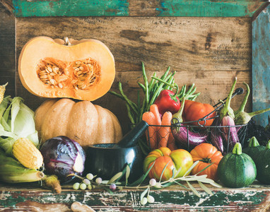 Assortment of various Autumn vegetables for healthy cooking on cupboard