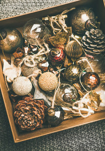 Christmas tree decoration toys and pine cones in wooden box