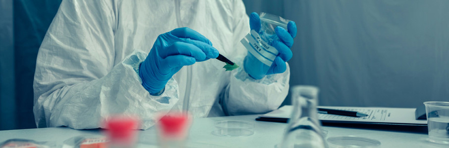 Scientist with protection suit doing research in the laboratory