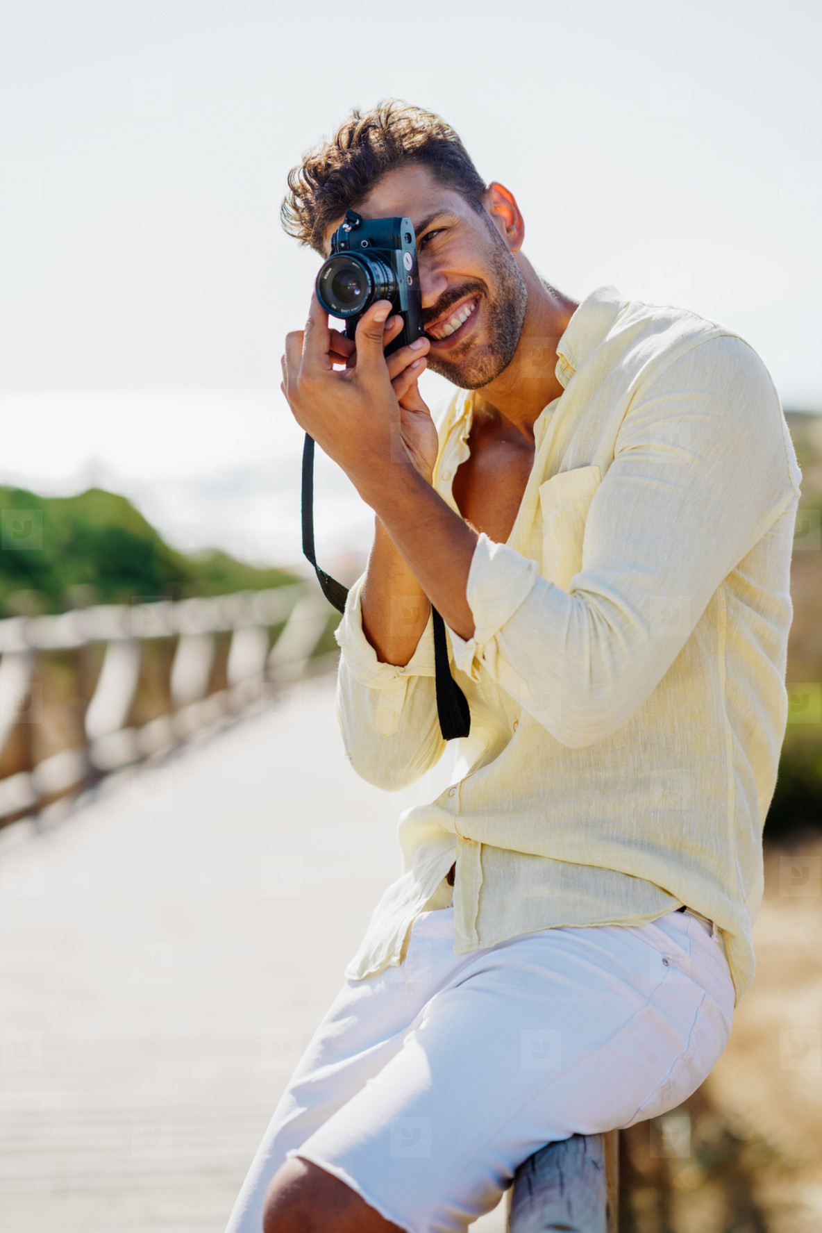 Handsome man photographing in a coastal area