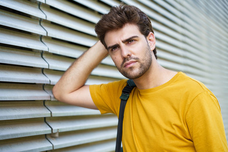 Young man with modern haircut in urban background