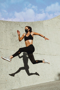 Woman in sportswear running and jumping