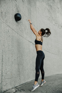 Female athlete exercising with a medicine ball