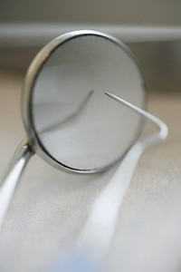Close up dental scraper and mirror