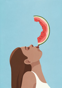 Playful young woman balancing watermelon slice on tongue