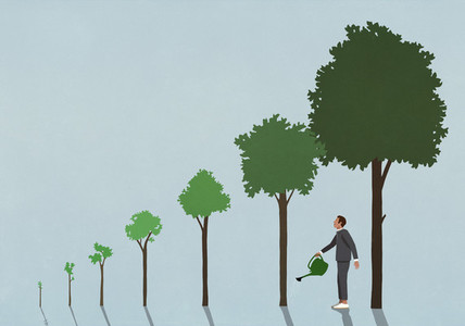 Businessman watering growing trees with watering can