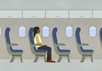 Woman riding airplane alone