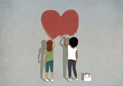 Multiethnic girls painting red heart on wall
