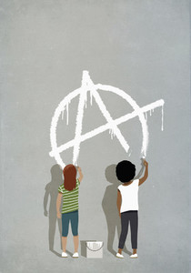 Girls painting anarchism symbol on gray wall