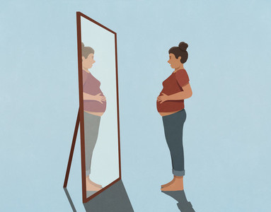 Pregnant young woman looking at reflection in mirror