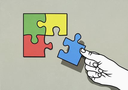 Hand completing puzzle with missing piece