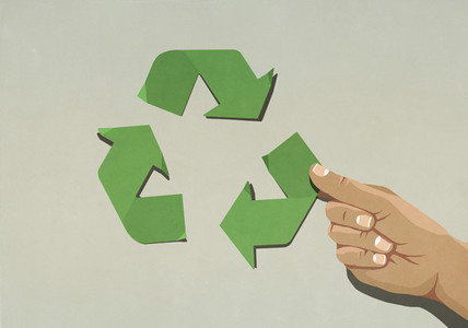 Hand assembling green recycling symbol arrows