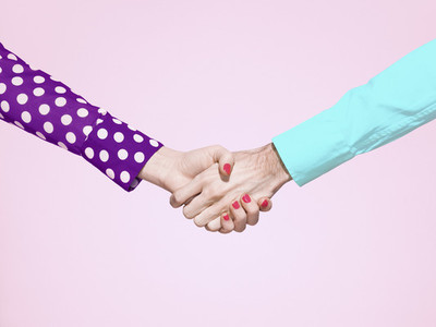 Vibrant handshake on pink background
