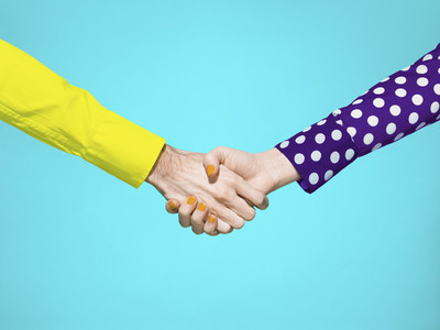 Vibrant handshake on turquoise background