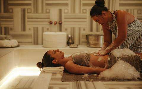 Woman experiencing traditional Turkish massage