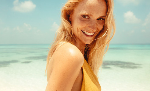 Portrait of freckled woman at a beach