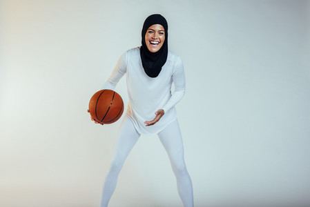 Cheerful basketball athlete on white background