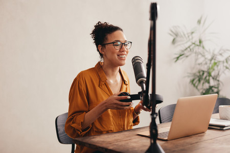 Woman recording her podcast from home