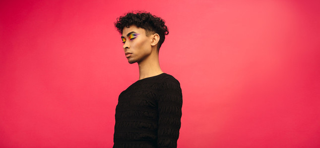 Young man with rainbow eye shadow makeup