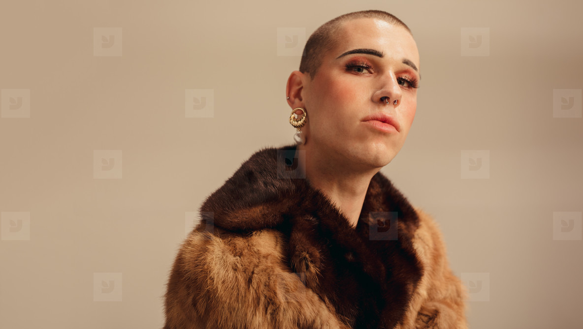 Handsome young man in a fur coat