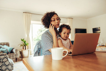 Mother with baby working from home