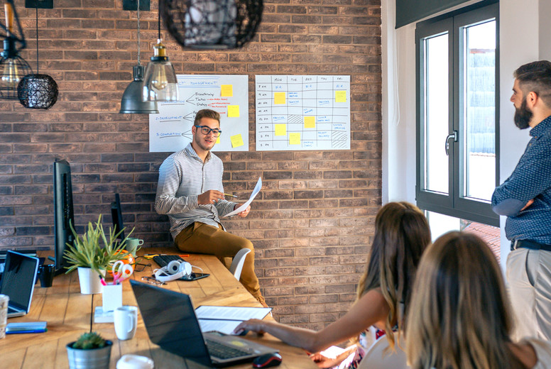 Coach giving a talk to workers in an office
