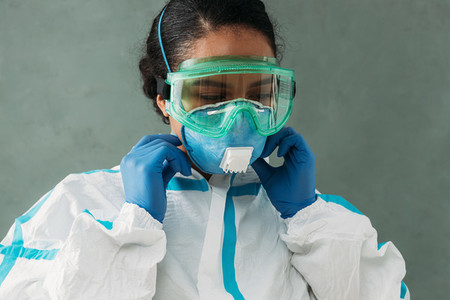 Young doctor in protective glasses and suit