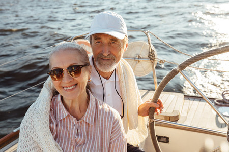 Elderly people enjoying a vacation on their sailboat