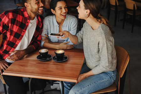 Group of friends meeting in a coffee shop
