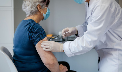Senior woman being vaccinated against coronavirus