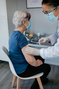 Senior woman being vaccinated against coronavirus