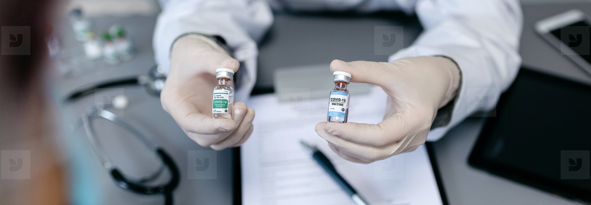 Doctor showing her patient two different coronavirus vaccine opt