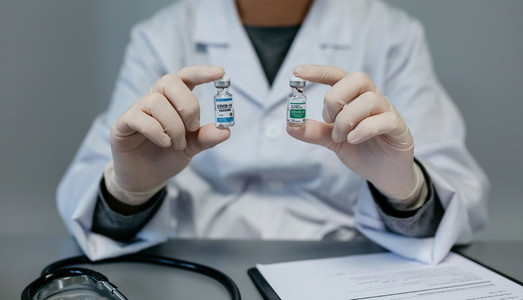 Doctor showing two coronavirus vaccine options