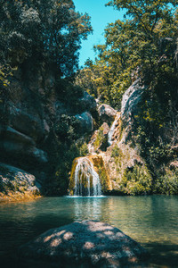 landscape of a small waterfall in a forest of tarragona  spain