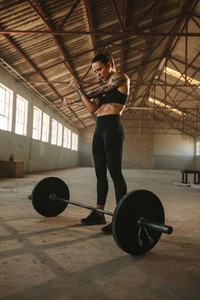 Woman weight lifter doing warm up workout