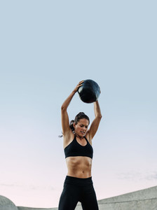 Fitness woman doing exercises using a medicine ball