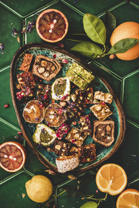 Turkish traditional lokum and fresh fruits over green tile table