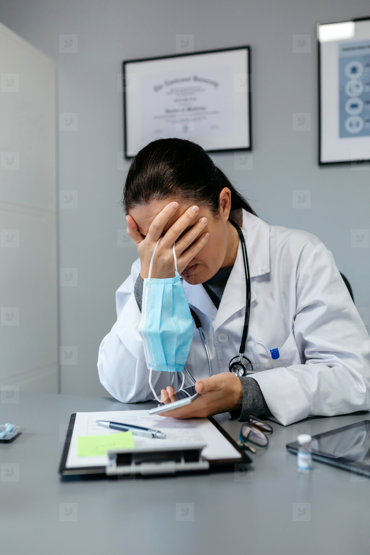 Worried female doctor with hands on face