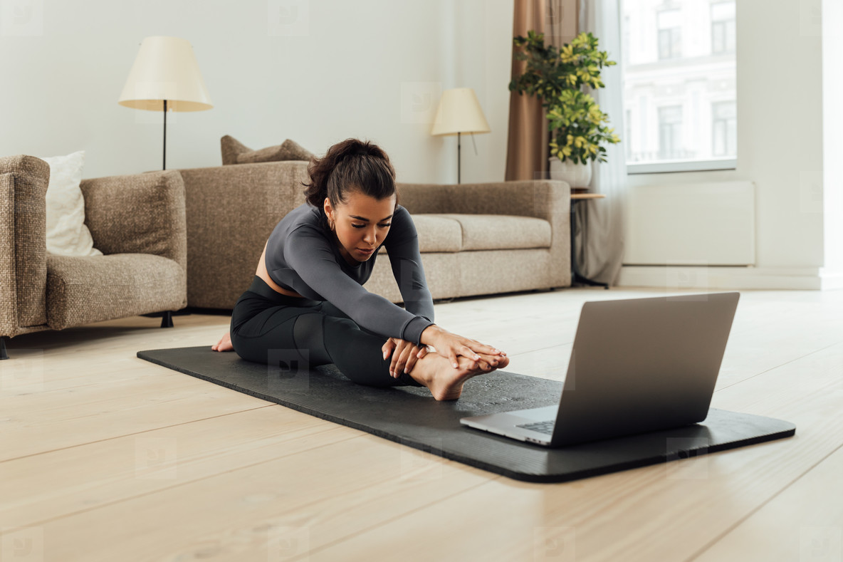 Mixed race woman repeating exercises from fitness instructor