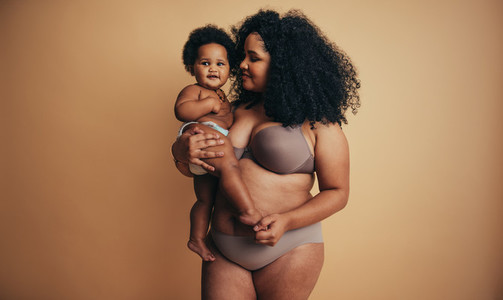Body positive healthy woman with her baby