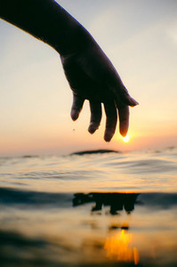 Silhouette hand shape sunset