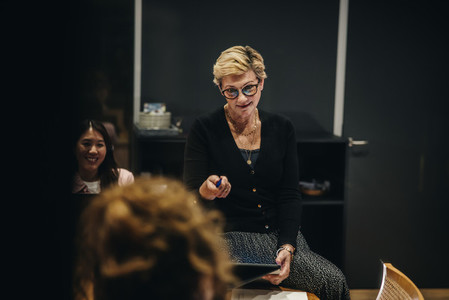 Female CEO giving instructions in meeting