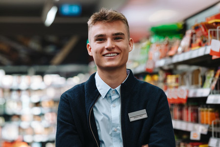Portrait of a young worker at supermarket