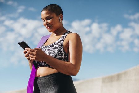 Health woman checking her fitness progress on smart phone