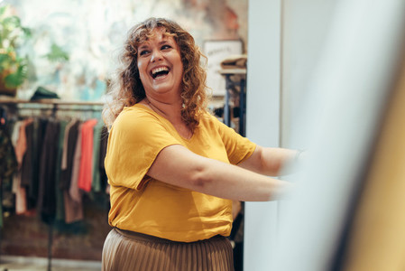 Happy shopper in clothing store